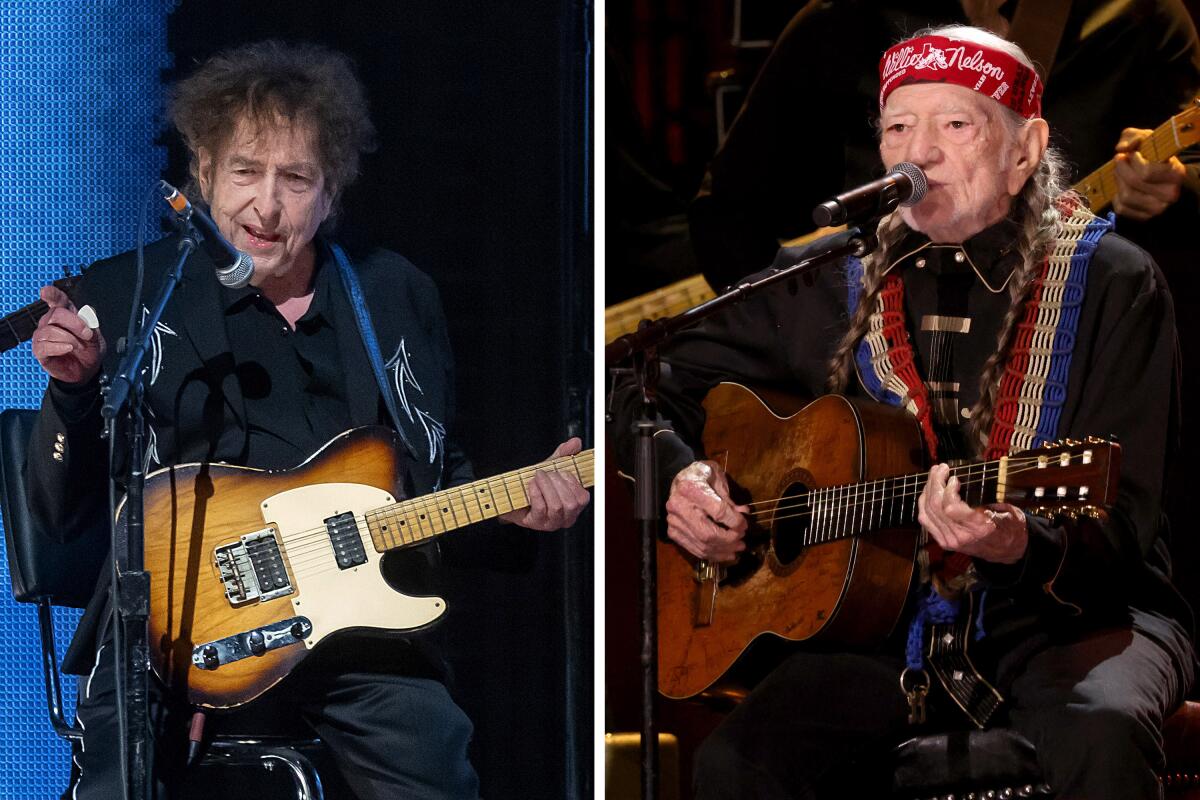 Left, Bob Dylan, left, and Willie Nelson hold guitars while performing onstage