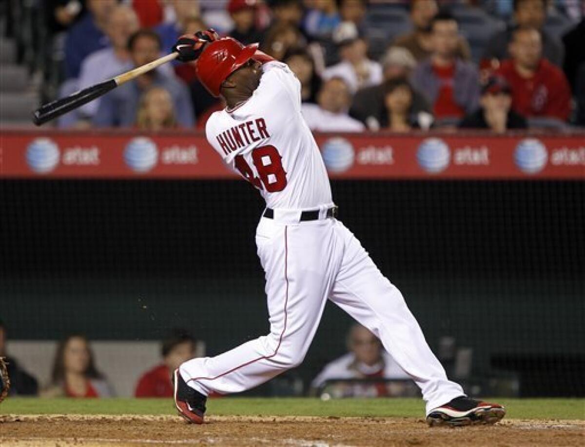 Los Angeles Angels' Torii Hunter follows through on a home run against the Cleveland Indians in the fifth inning of a baseball game Tuesday, Sept. 7, 2010, in Anaheim, Calif. (AP Photo/Alex Gallardo)