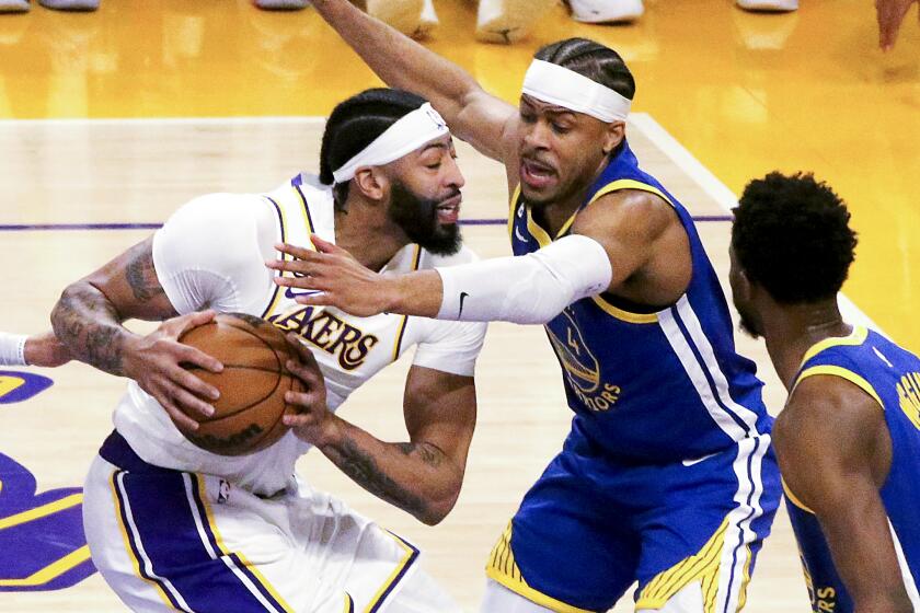 Los Angeles, CA - May 06: Los Angeles Lakers forward Anthony Davis, left, drives to the basket against Golden State Warriors guard Moses Moody during the first half in Game 3 of the NBA Western Conference semifinals at Crypto.com Arena in Los Angeles on Saturday, May, 2023. Los Angeles on Saturday, May 6, 2023 in Los Angeles, CA. (Luis Sinco / Los Angeles Times)