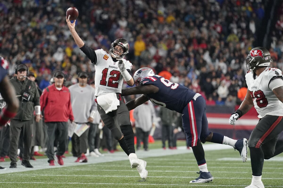 Tampa Bay Buccaneers quarterback Tom Brady throws under pressure against the Patriots.