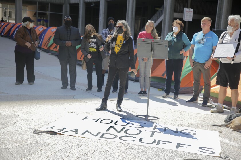 Local attorney and homeless advocate Coleen Cusack speaks at a vigil for homeless people at the San Diego Concourse.