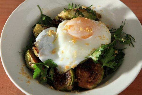 At Sqirl, breakfast can be roasted Brussels sprouts, mixed greens, Chicharron crumbs and a poached egg.