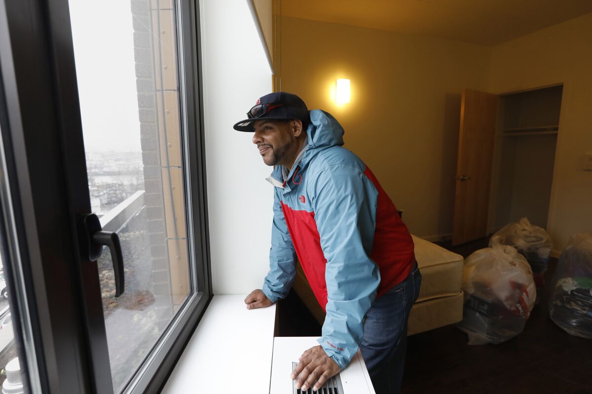 Jesus Melendez, 46, looks at the view out his new studio apartment at Landing Road, a newly opened shelter and long-term housing facility in the Bronx.