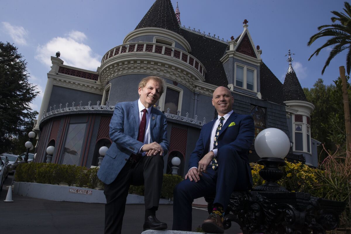 Two men outside the Magic Castle.