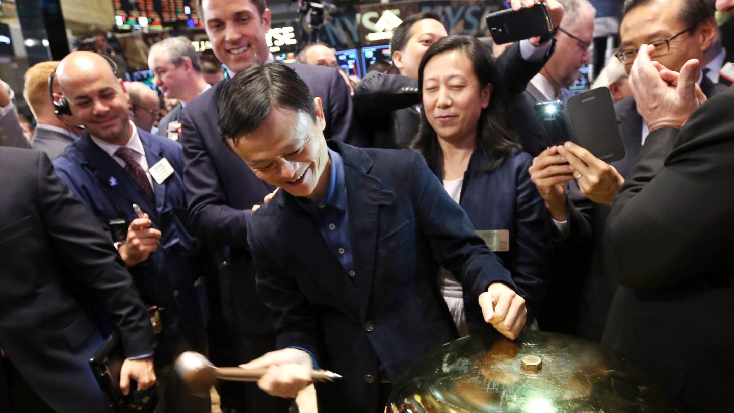 Jack Ma, center, the founder and executive chairman of Alibaba, rings a ceremonial bell on the floor of the New York Stock Exchange during the first trading of shares in the Chinese company's initial public offering in New York.