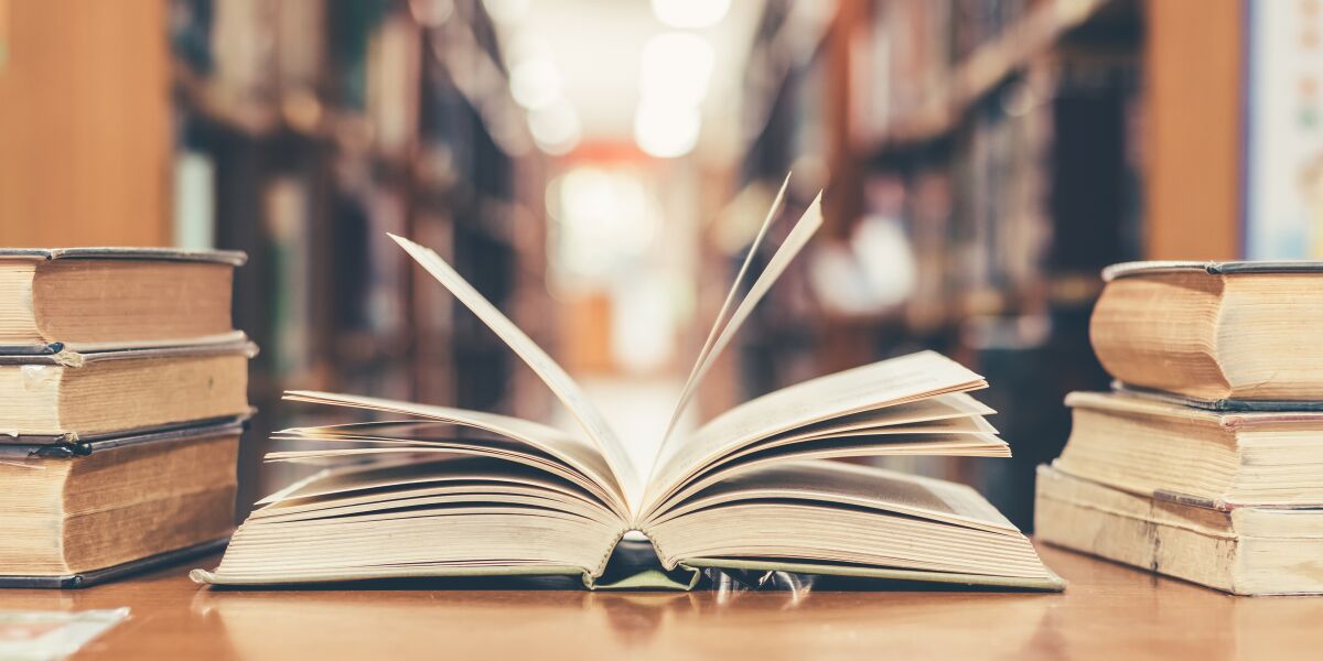 An open book on a table in a library.