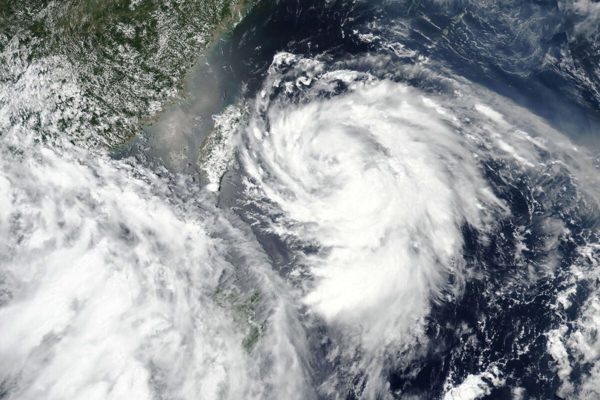 This Sunday, Aug. 2, 2020, satellite image released by NASA shows Typhoon Hagupit approaching Taiwan, center left. Vulnerable coastal areas of eastern China are being evacuated in anticipation of Typhoon Hagupit making landfall late Monday, Aug. 3, 2020, bringing gales and heavy rainfall at a time when much of the country is still recovering from unusually summer heavy flooding. (NASA Worldview, Earth Observing System Data and Information System (EOSDIS) via AP)