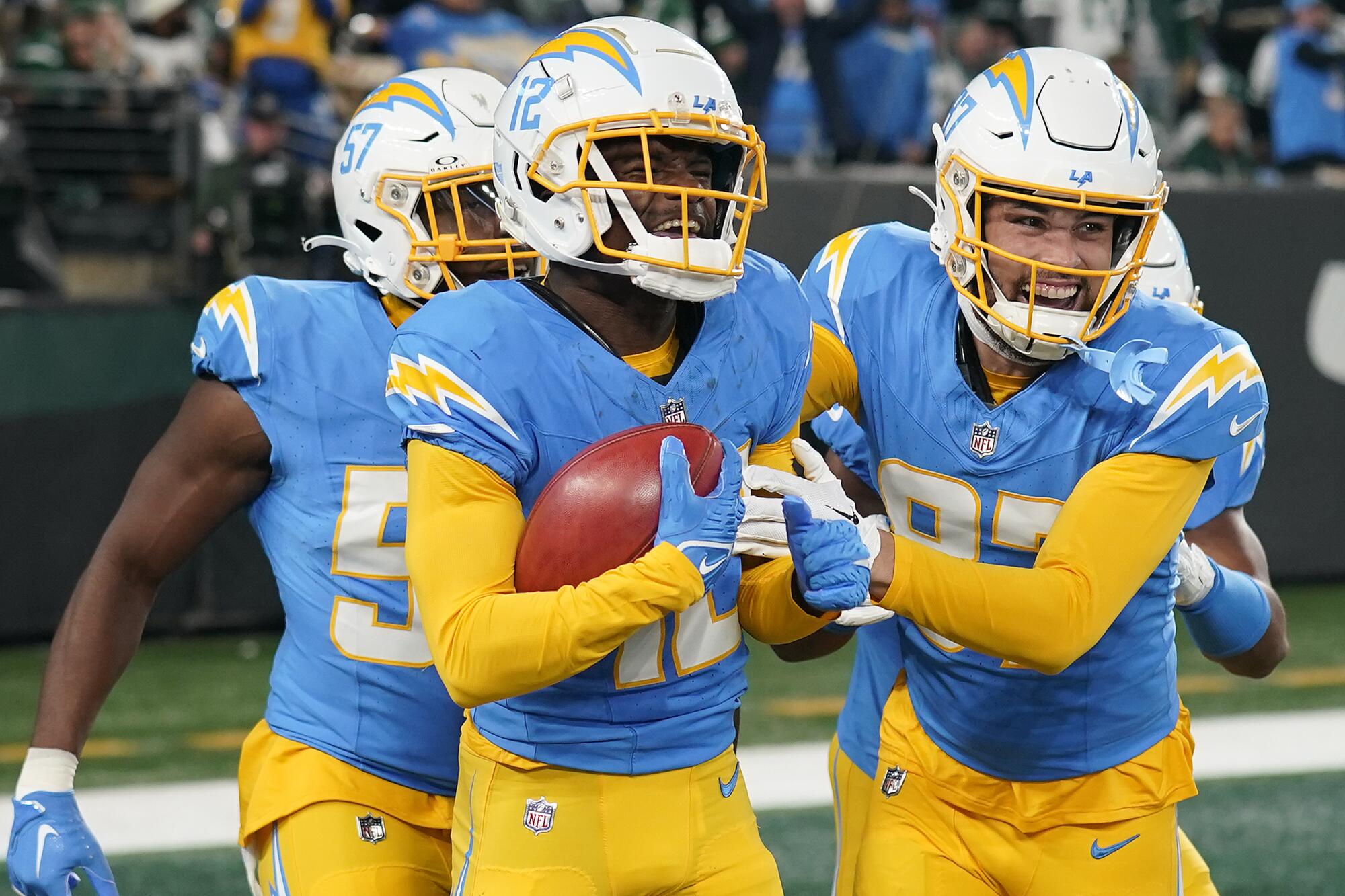 Derius Davis, left, celebrates with teammates after scoring on an 87-yard punt return against the New York Jets.