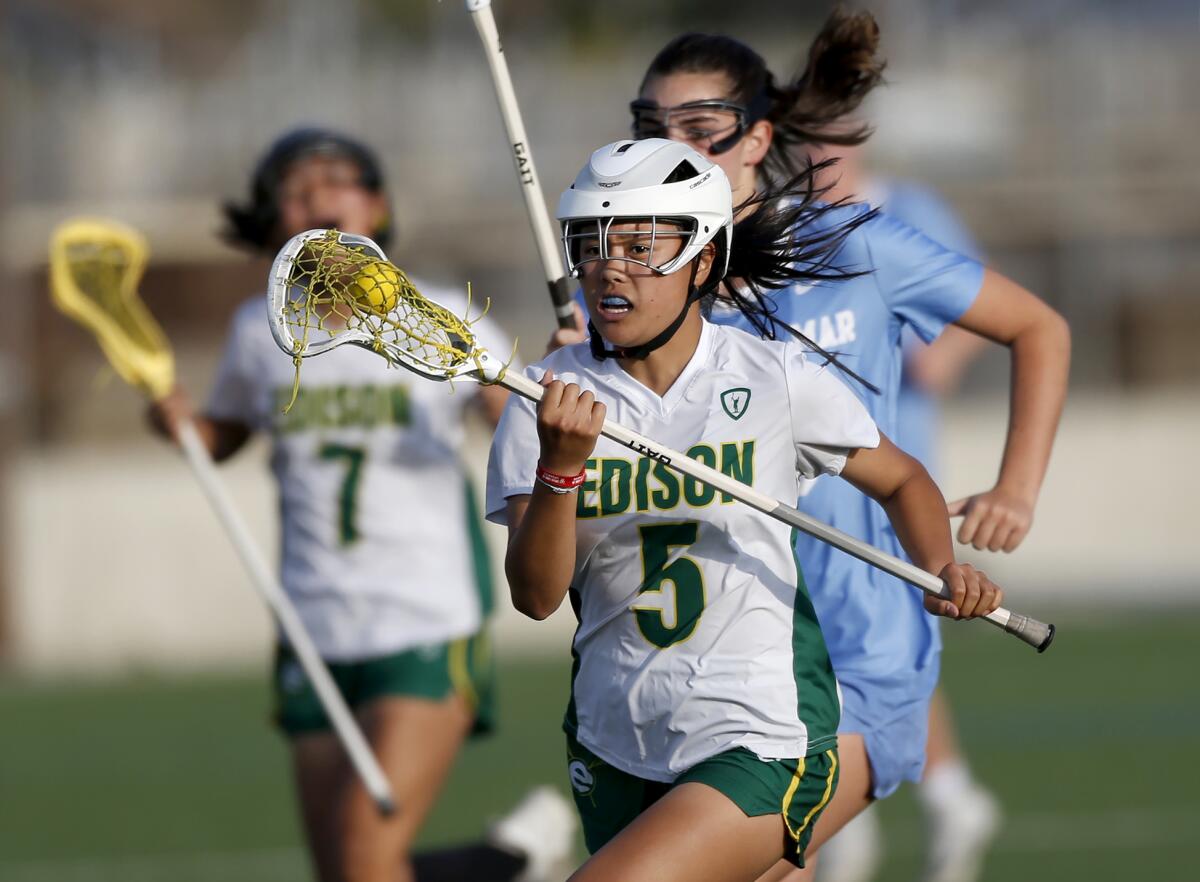 Edison's Sofia Chock makes a run for the goal during the Sunset League girls' lacrosse finale against Corona del Mar.