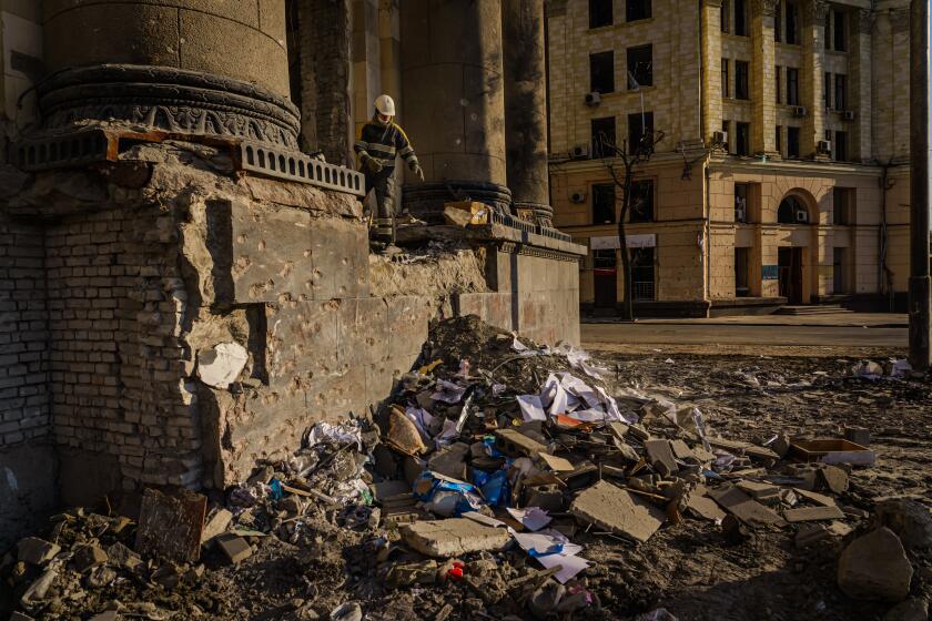 KHARKIV, UKRAINE -- MARCH 25, 2022: Firefighters clean up debris inside the Kharkiv Regional Administration building after it was destroyed by Russian bombardments, in Kharkiv, Ukraine, Friday, March 25, 2022. (MARCUS YAM / LOS ANGELES TIMES)