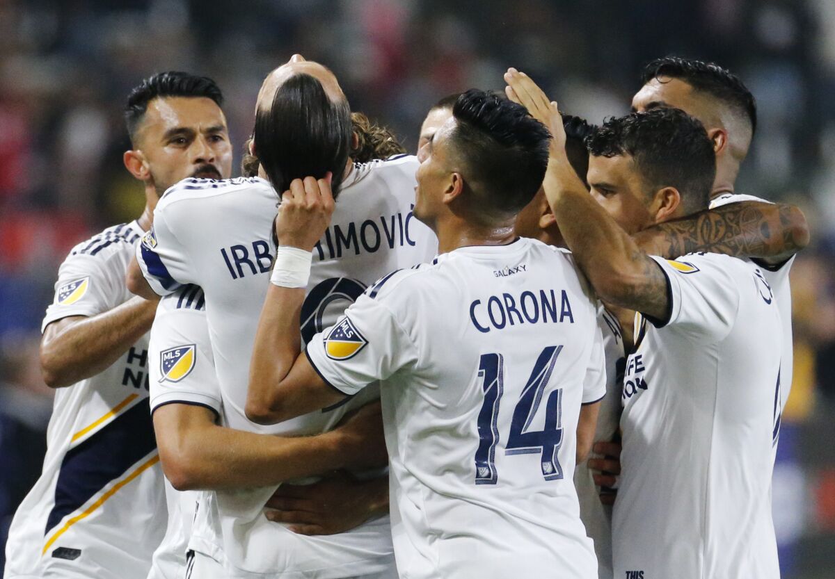 LA Galaxy forward Zlatan Ibrahimovic (9) of Sweden, celebrates his goal with teammates against Toronto FC during an MLS soccer match in Carson, Calif., Thursday, July 4, 2019. The Galaxy won 2-0. (AP Photo/Ringo H.W. Chiu)