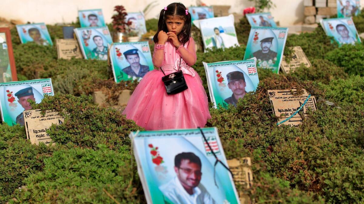 A Yemeni girl stands near the graves of relatives in a cemetery in the capital Sana'a on Friday.