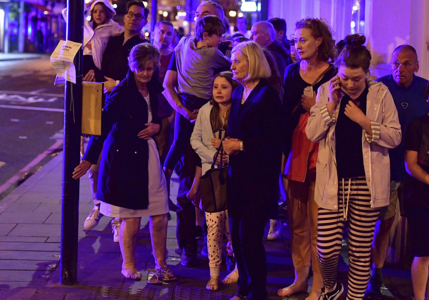 People walk down Borough High Street after the attack on London Bridge.
