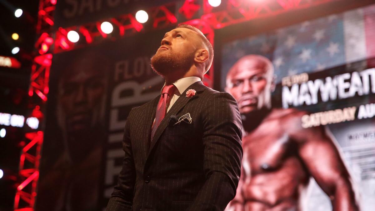 UFC champion Conor McGregor takes the stage during his promotional tour with unretired boxing champion Floyd Mayweather Jr. at their stop in Los Angeles on Tuesday.