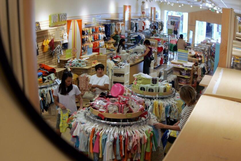 A security mirror shows shoppers at a Gymboree store at Stanford Shopping Center in Palo Alto, Calif., Wednesday, July 6, 2005. The arrival of summer gave the nation's retailers their best showing in months in June . (AP Photo/Paul Sakuma) ORG XMIT: NY857