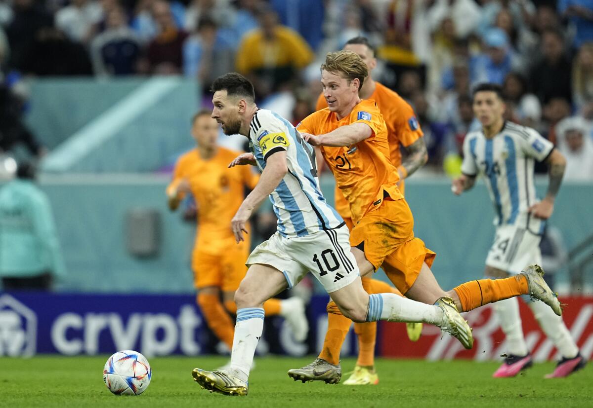 Argentina's Lionel Messi, front, controls the ball against Frenkie de Jong of the Netherlands.