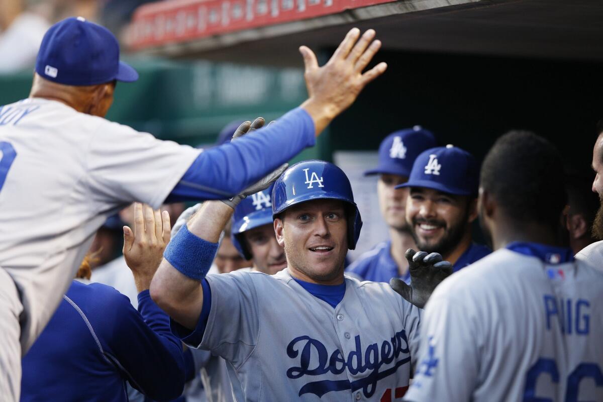A.J. Ellis celebrates with teammates Wednesday after hitting a two-run home run against Cincinnati.