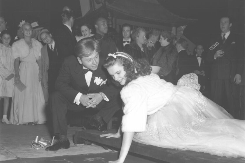 Mickey Rooney watches Judy Garland put her handprint in cement at Grauman's Chinese Theatre on Oct. 25, 1939.