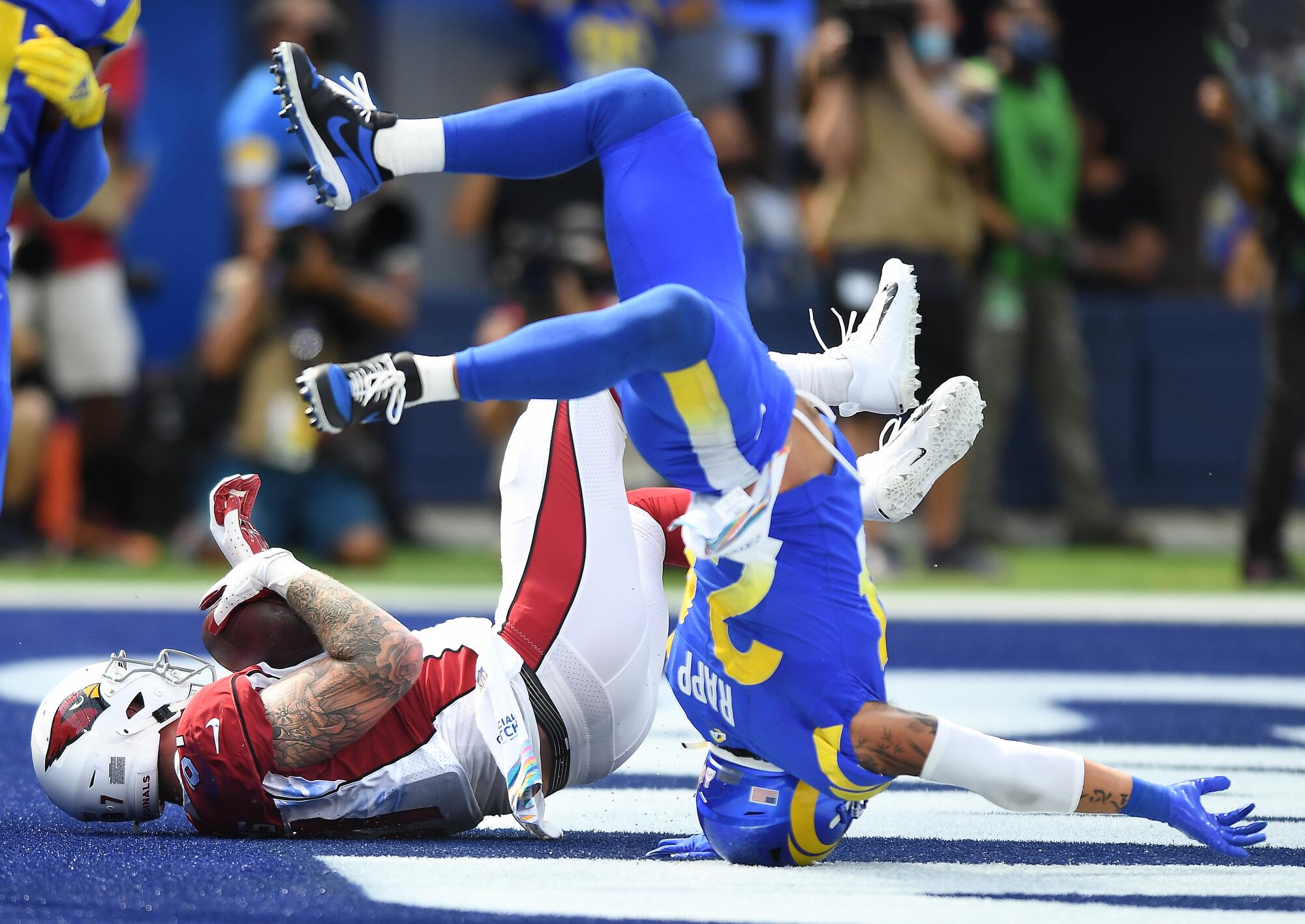 Cardinals tight end Maxx Williams falls after a catch while Rams safety Taylor Rapp defends.