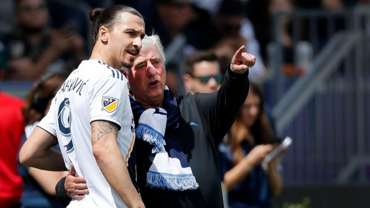 Zlatan Ibrahimovic confers with Galaxy coach Sigi Schmid as he prepares to enter a game against LAFC at StubHub Center.