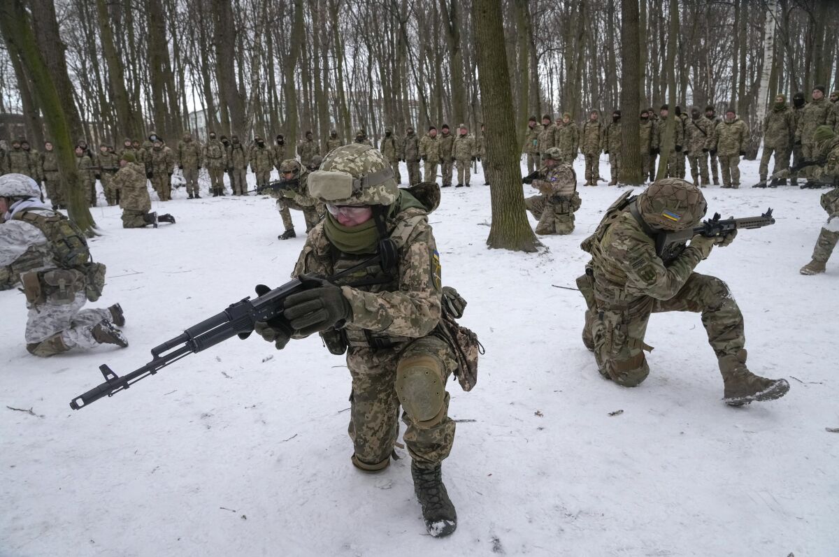 Volunteer soldiers train with guns in Ukraine.