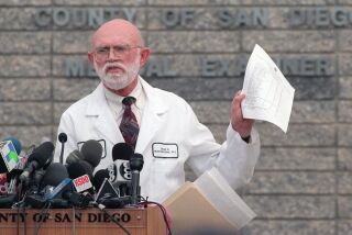 medex2 County Medical Examiner Brian Blackbourne holds the updated list of the names of 39 members of Heaven's Gate that died in a mass suicide last week, during the last press conference at the medical examiner's office. Two families could not be found to notify them of the suicides.--LAURA EMBRY/UT