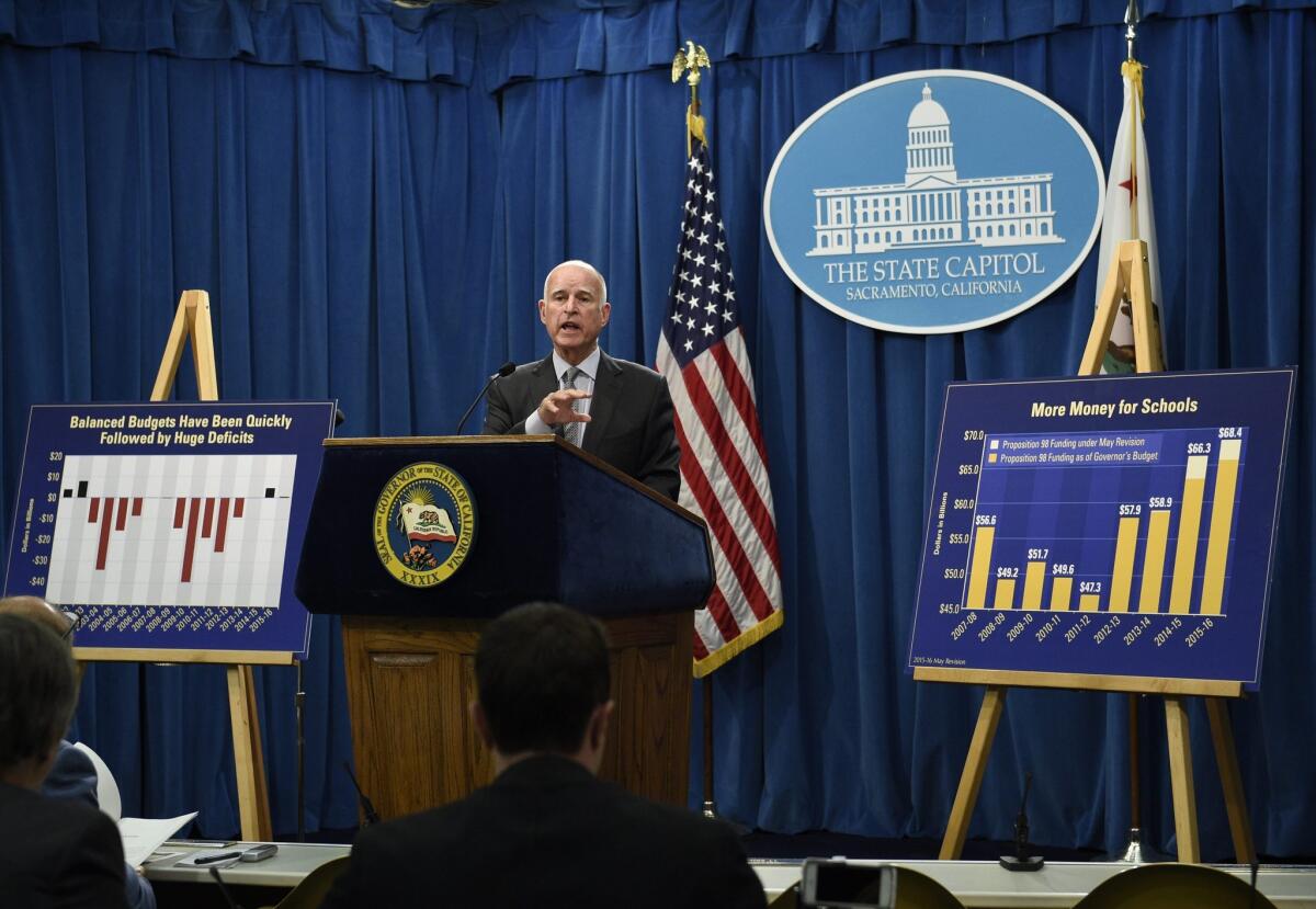 Gov. Jerry Brown unveils his revised 2015-16 California budget proposal during a news conference in Sacramento May 14.