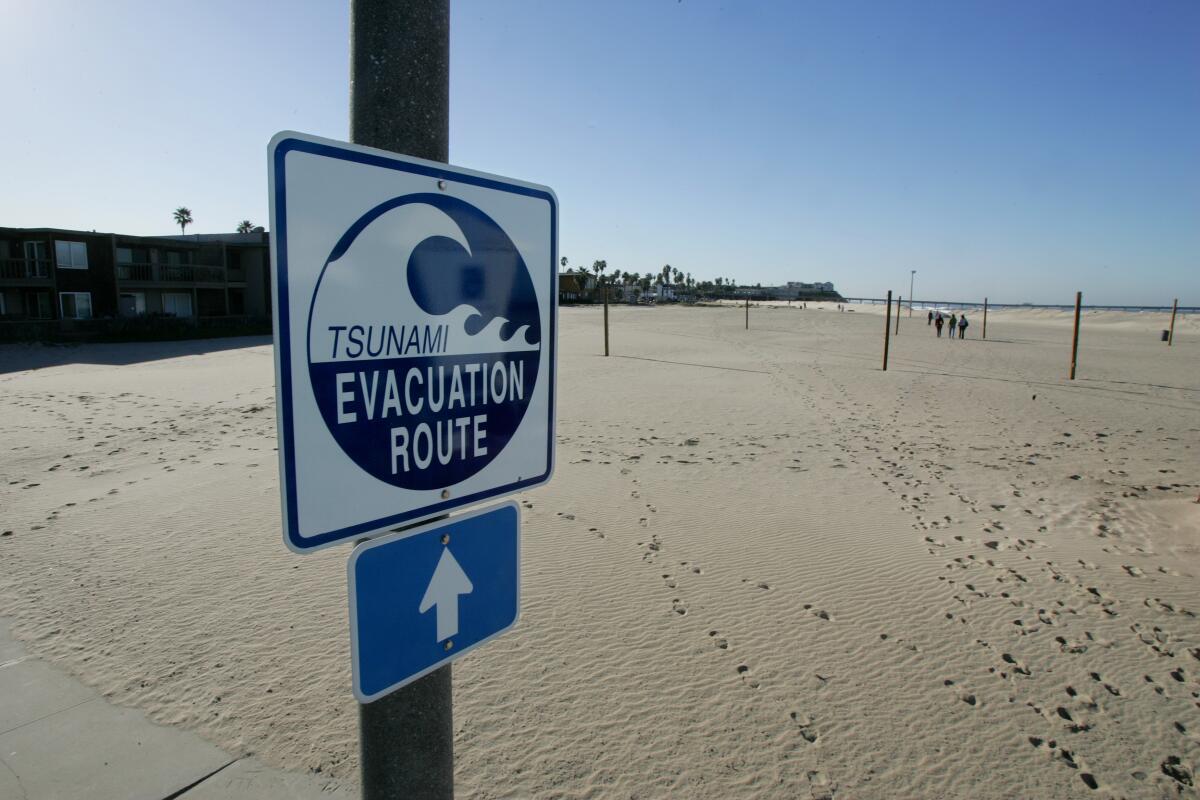 Tsunami evacuation route sign at the corner of Spray Street and Brighton Avenue in the Ocean Beach neighborhood of San Diego