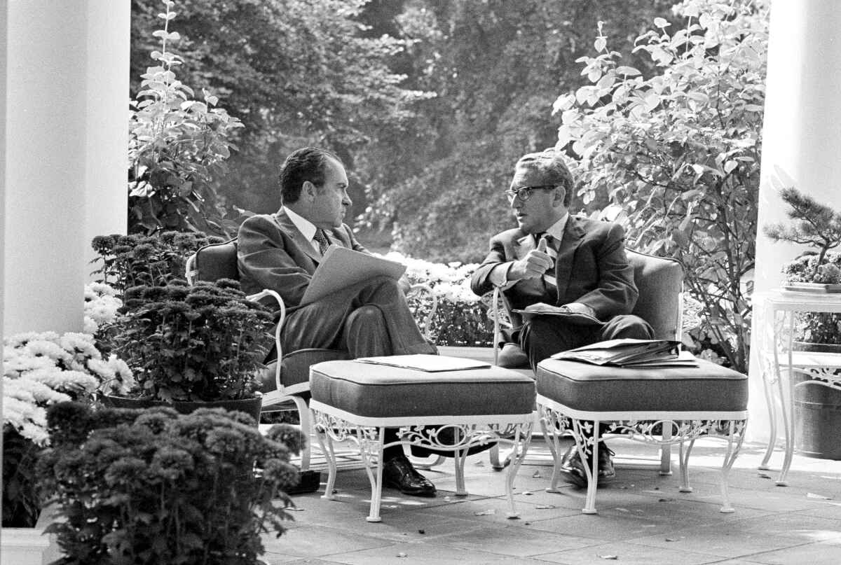 Richard Nixon and Henry Kissinger on a patio
