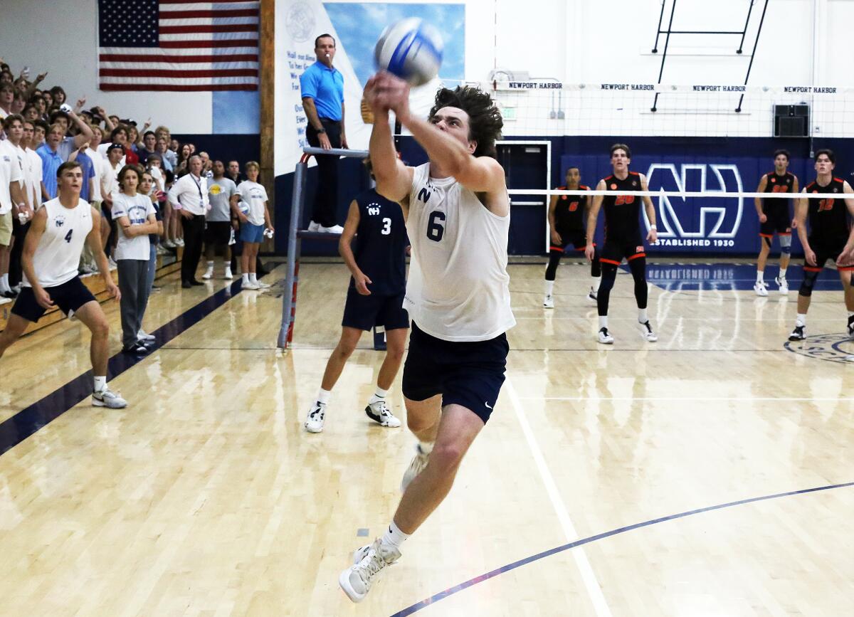 Newport Harbor's Jake Read (6) keeps the ball in play against Huntington Beach on Wednesday.