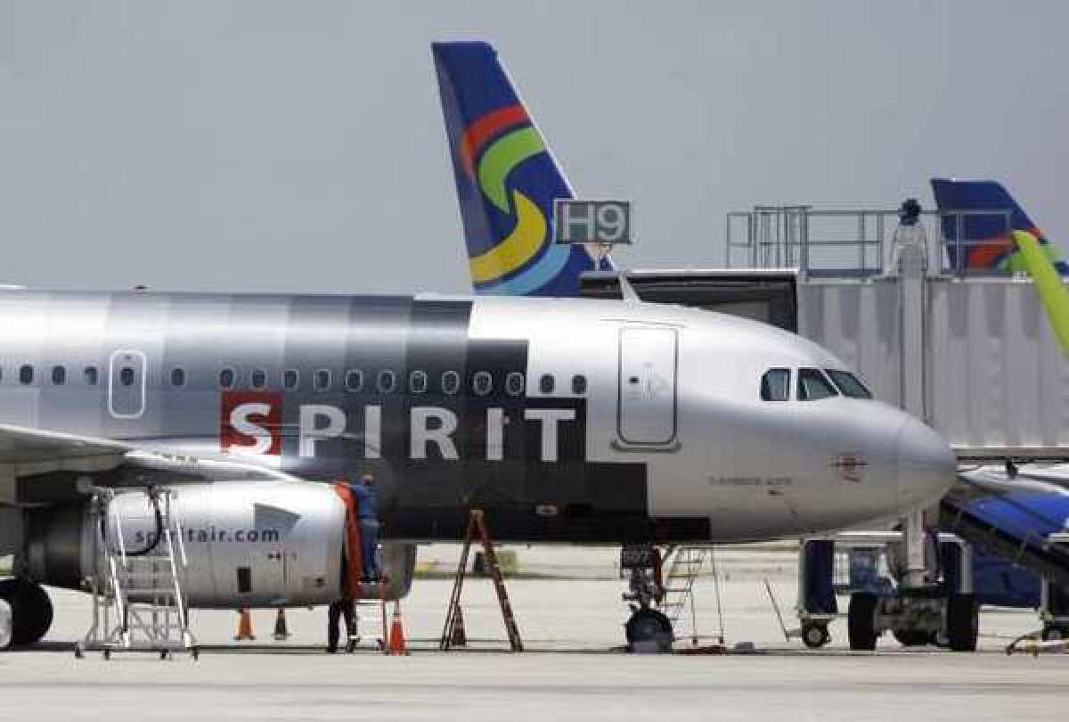 A Spirit Airlines plane sits on a tarmac.