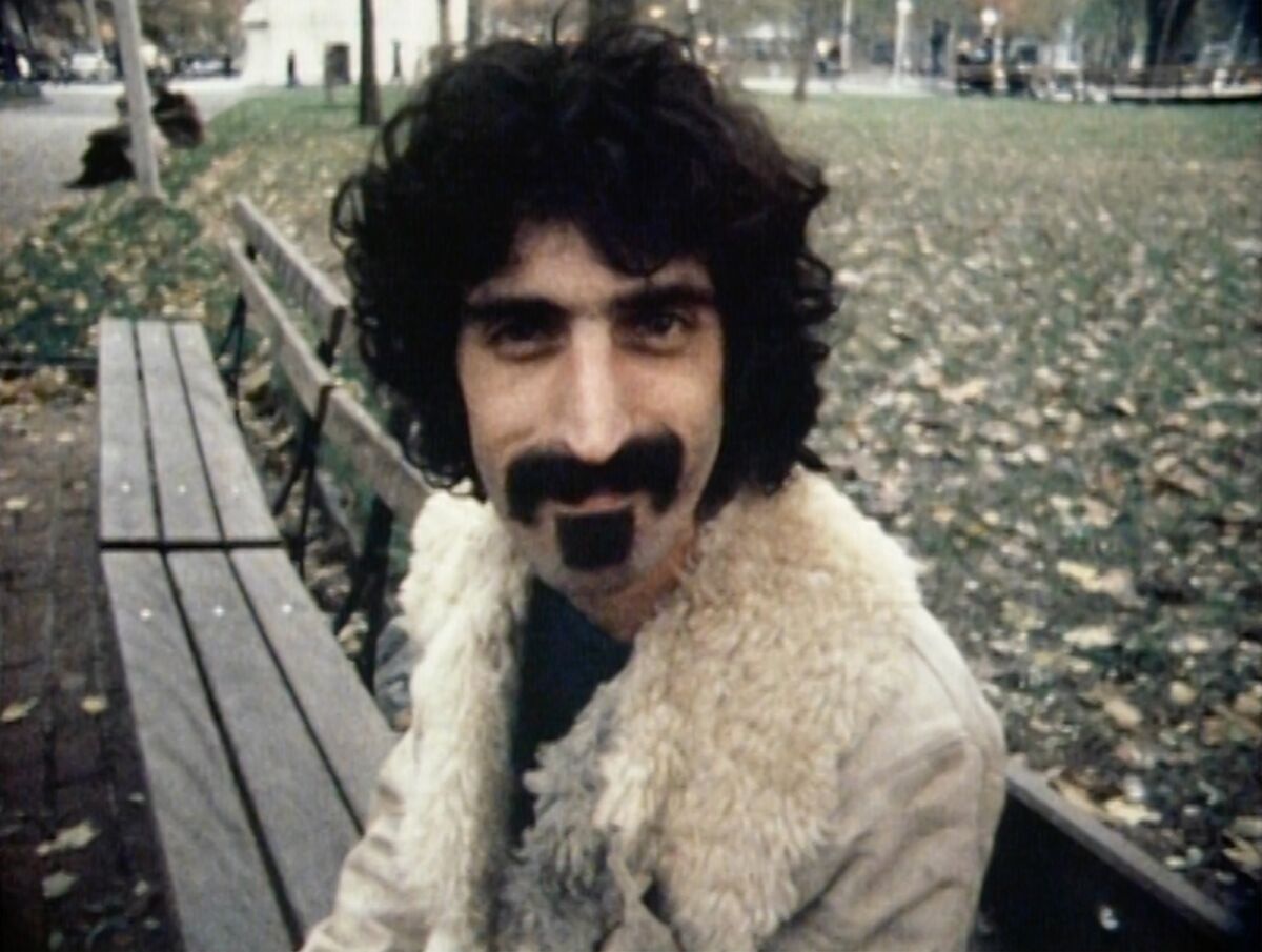 Frank Zappa on a park bench in the documentary "Zappa."