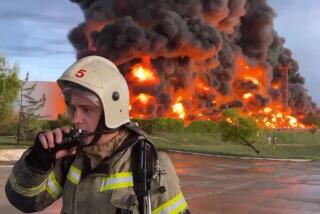 An image taken from video shows a firefighter at the scene of a burning fuel tank in Sevastopol, Crimea, on Saturday.