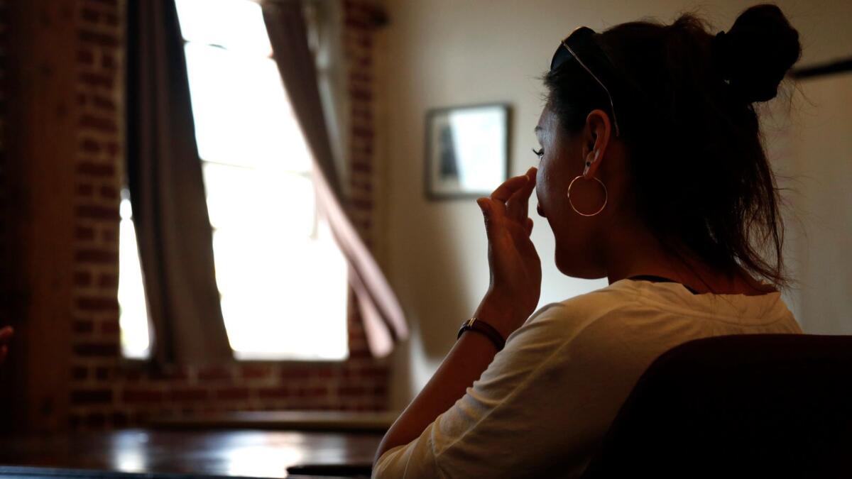 Maria wipes a tear from her eye after conveying her fears of being deported back to Mexico for petty theft and other charges while being interviewed at the Central American Resource Center.