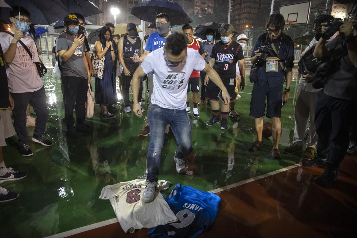 A demonstrator in Hong Kong stomps on LeBron James jerseys.