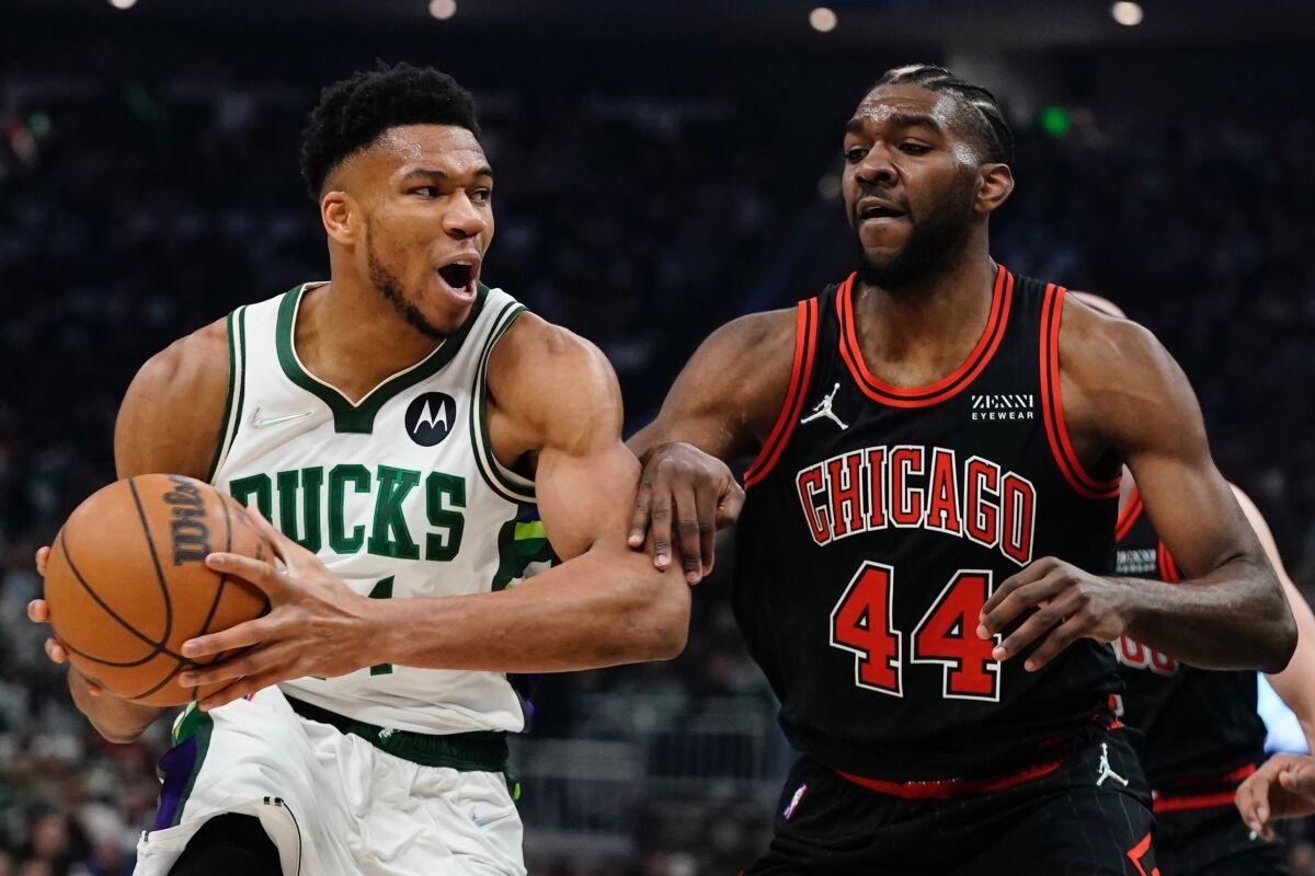 Milwaukee Bucks' Giannis Antetokounmpo tries to get past Chicago Bulls' Patrick Williams during the first half of Game 1 of their first round NBA playoff basketball game Sunday, April 17, 2022, in Milwaukee . (AP Photo/Morry Gash)