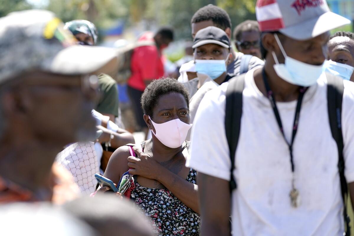 Residents of Galveston, Texas, wait to board buses to evacuate.