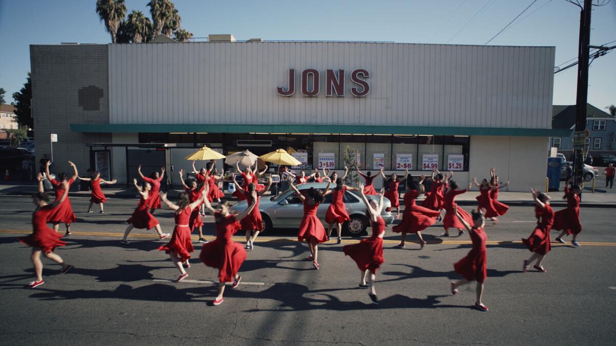 Dancers in the parking lot of a supermarket in the movie "Summertime."