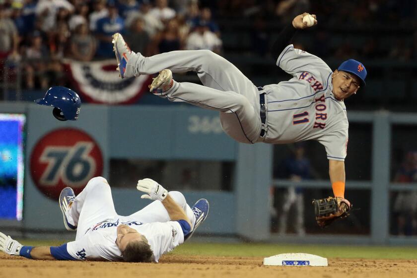 The Dodgers' Chase Utley upends Mets infielder Ruben Tejada at second base in Game 2 of the National League division series.