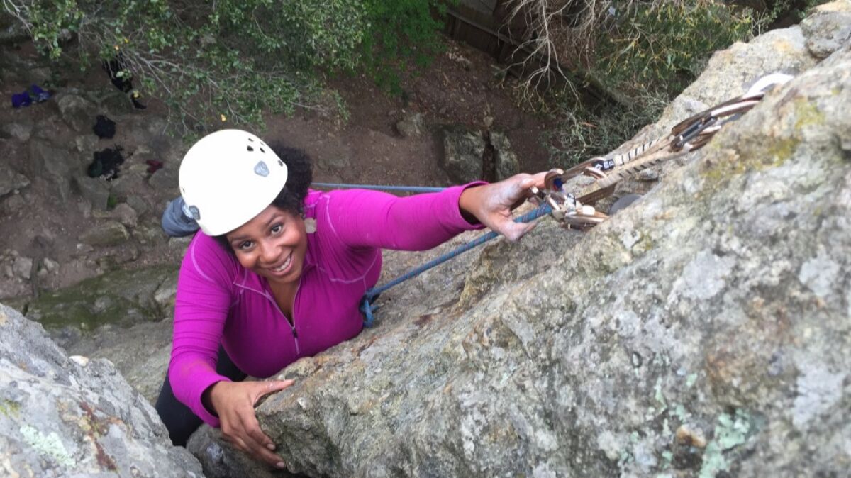 Rue Mapp climbing a rock face