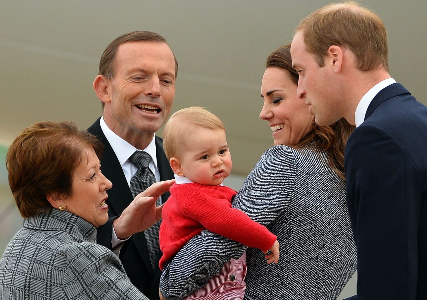 Lynne Cosgrove, left, wife of the governor-general of the Commonwealth of Australia, and Australian Prime Minister Tony Abbott see off Britain's Prince William, his wife, Catherine, and their son, Prince George, at the Defense Establishment Fairbairn in Canberra.