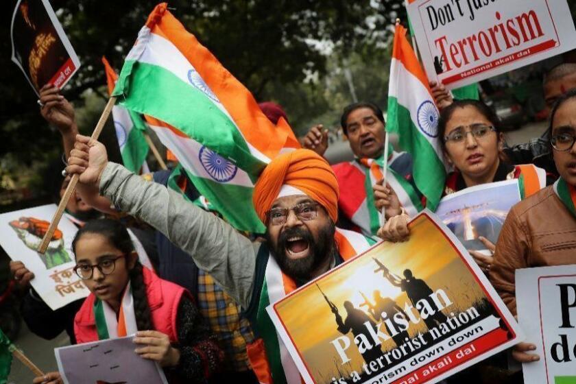A National Akali Dal leader shouts slogans in support of India and against Pakistan as he celebrates reports of Indian aircrafts bombing Pakistan territory, in New Delhi, India, Tuesday, Feb. 26, 2019. Pakistan says Indian aircraft crossed into its territory and dropped bombs on Tuesday without causing casualties, in the latest escalation between the nuclear-armed rivals since a deadly attack on Indian troops in the disputed Kashmir region sent tensions soaring. (AP Photo/Altaf Qadri)