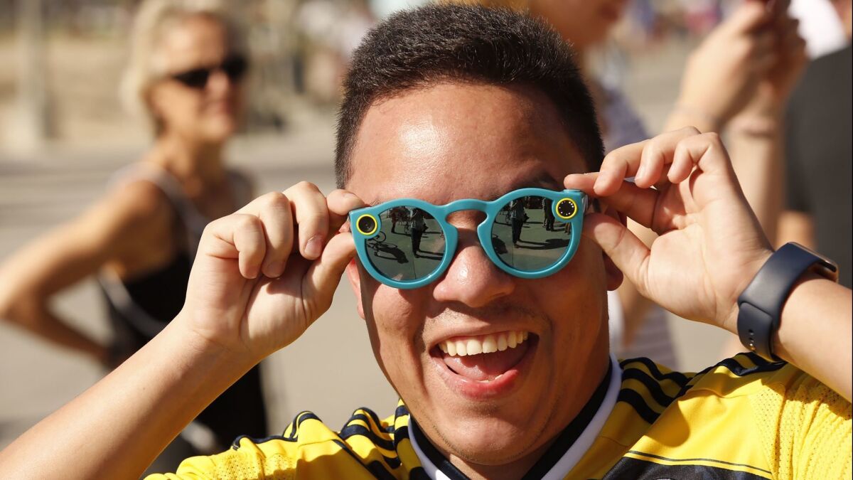 Albert Borrero of Los Angeles tries on the first version of Spectacles in Venice shortly after they went on sale in 2016.