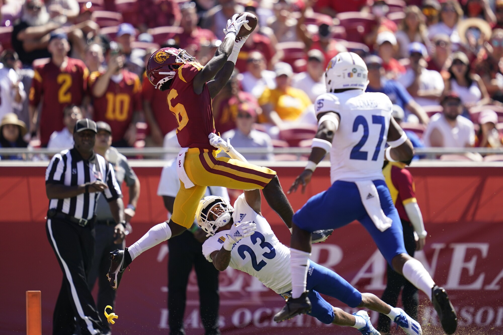 USC wide receiver Tahj Washington catches a pass in the end zone.