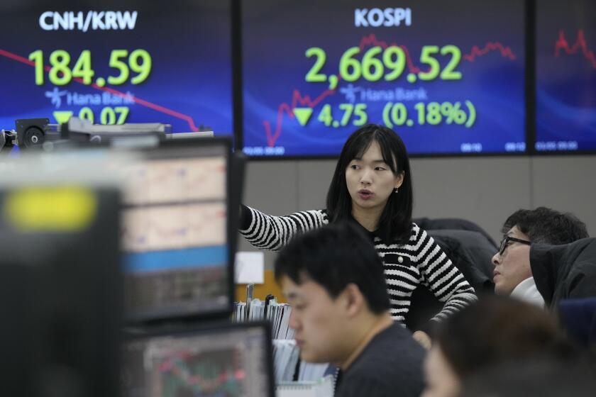 Currency traders watch monitors at the foreign exchange dealing room of the KEB Hana Bank headquarters in Seoul, South Korea, Tuesday, March 5, 2024. Shares were mixed Tuesday in Asia after China’s premier said the country’s target for economic growth this year is around 5%, in line with expectations. (AP Photo/Ahn Young-joon)