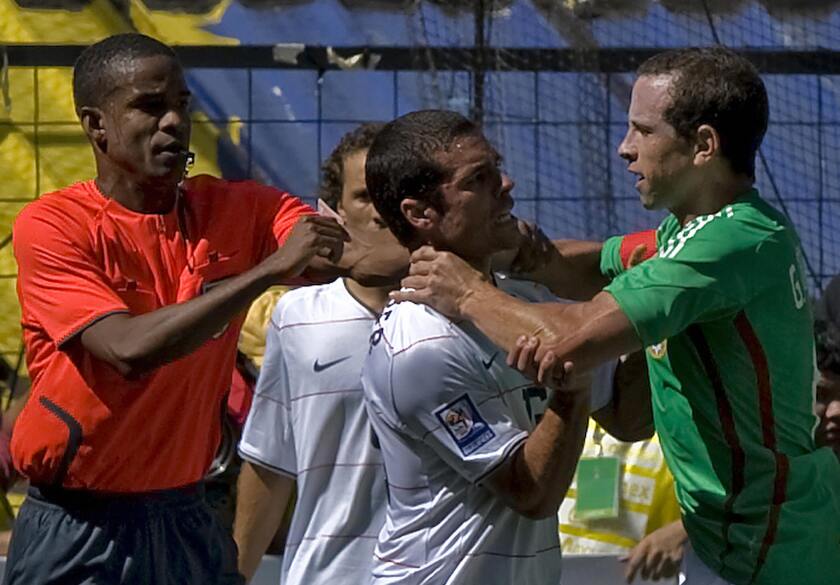 Mexican Gerardo Torrado fights with American Benny Feilhaber during a FIFA World Cup qualifier at Estadio Azteca