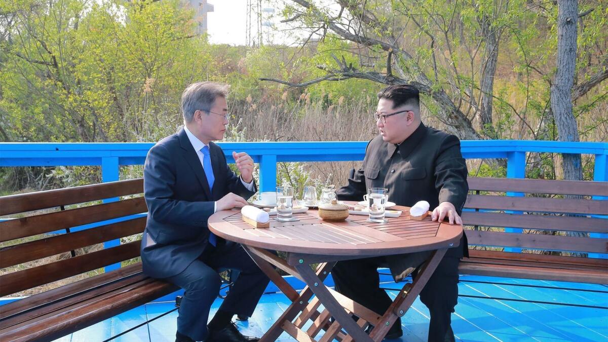 North Korean leader Kim Jong Un, right, talks with South Korean President Moon Jae-in at the truce village of Panmunjom.