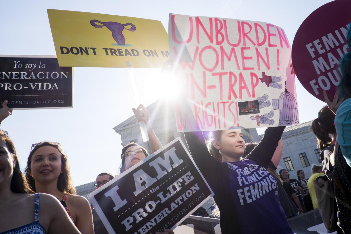 Abortion-rights activists and abortion foes wait for rulings in front of the U.S. Supreme Court in Washington on Monday.