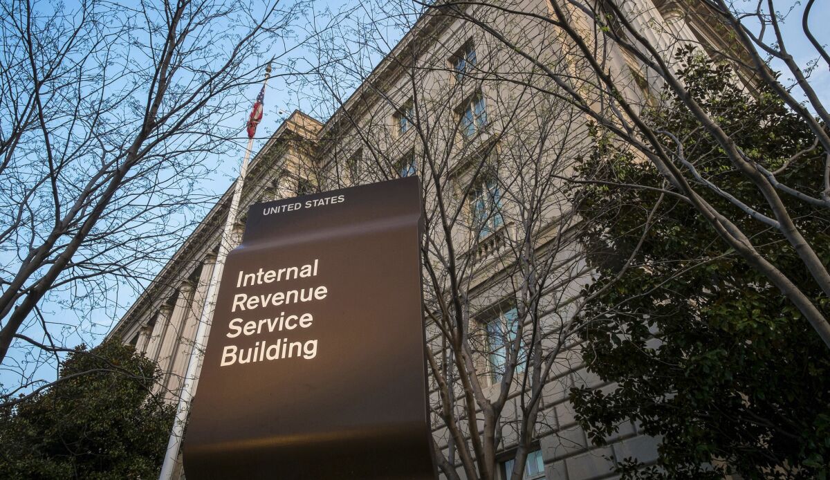 A sign next to a U.S. flag reads Internal Revenue Service in front of building 