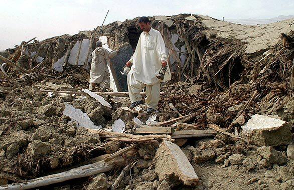 A villager walks among the rubble of his home in Ziarat, about 80 miles south of Quetta, Pakistan, where Wednesday morning's quake was centered.